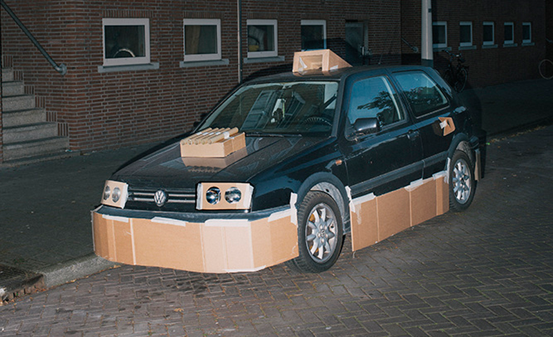 Illustration for article titled This Artist Turns Boring Rides Into Supercars At Night Using Cardboard